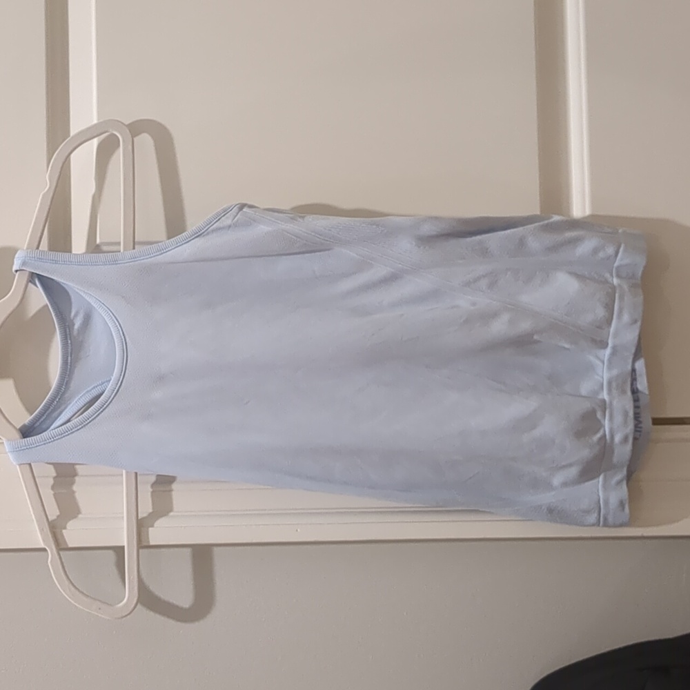 A light blue size girls 12 razer back tank top from athleta.